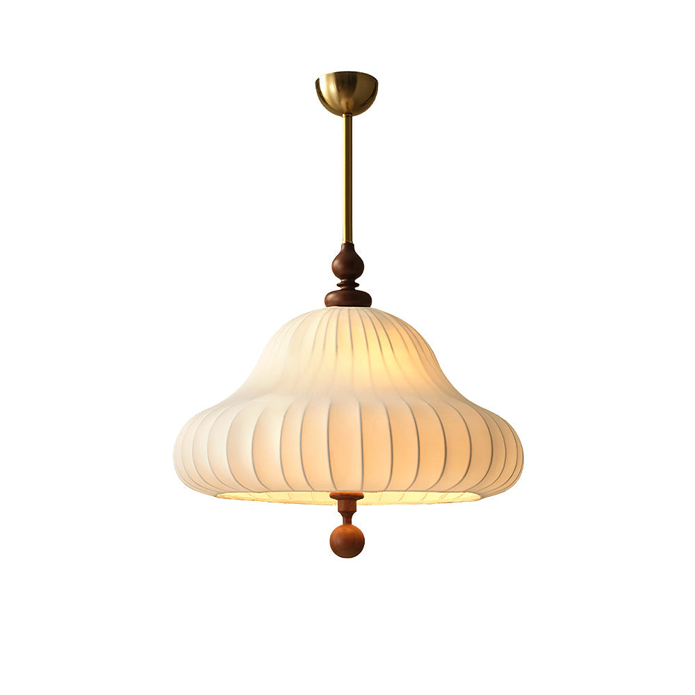 Cut-out view of this Clérachic pendant on white, with a brass canopy and rod above a lit white pleated shade and walnut ball.