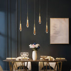The five-light Clérachic Gold-Flecked Glass Teardrop Pendant Light staggered over a dining table set with roses and crystal.