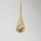 The polished gold cone of a Clérachic teardrop pendant with its glass removed, showing the integrated LED module inside.