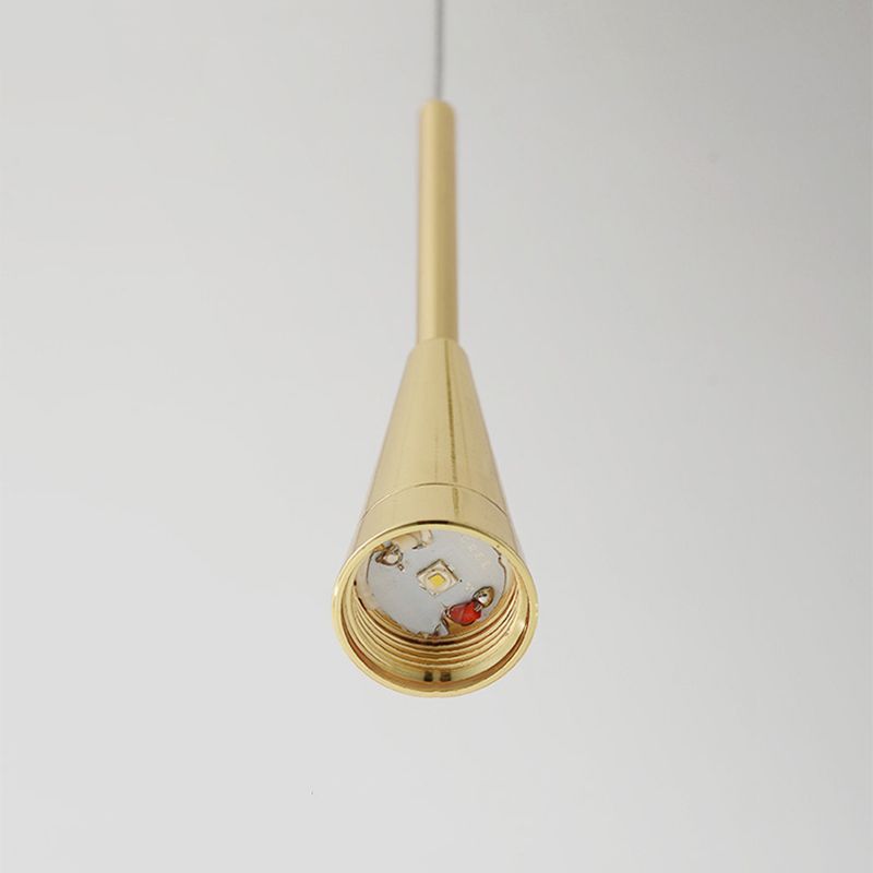 The polished gold cone of a Clérachic teardrop pendant with its glass removed, showing the integrated LED module inside.