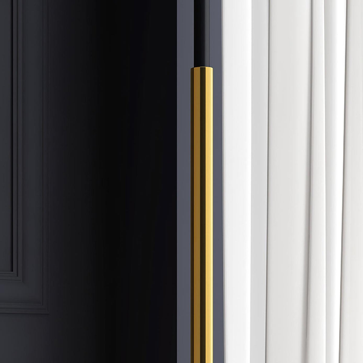 Detail of the slim gold stem of this Clérachic floor lamp, with a dark wall on one side and a white curtain on the other.