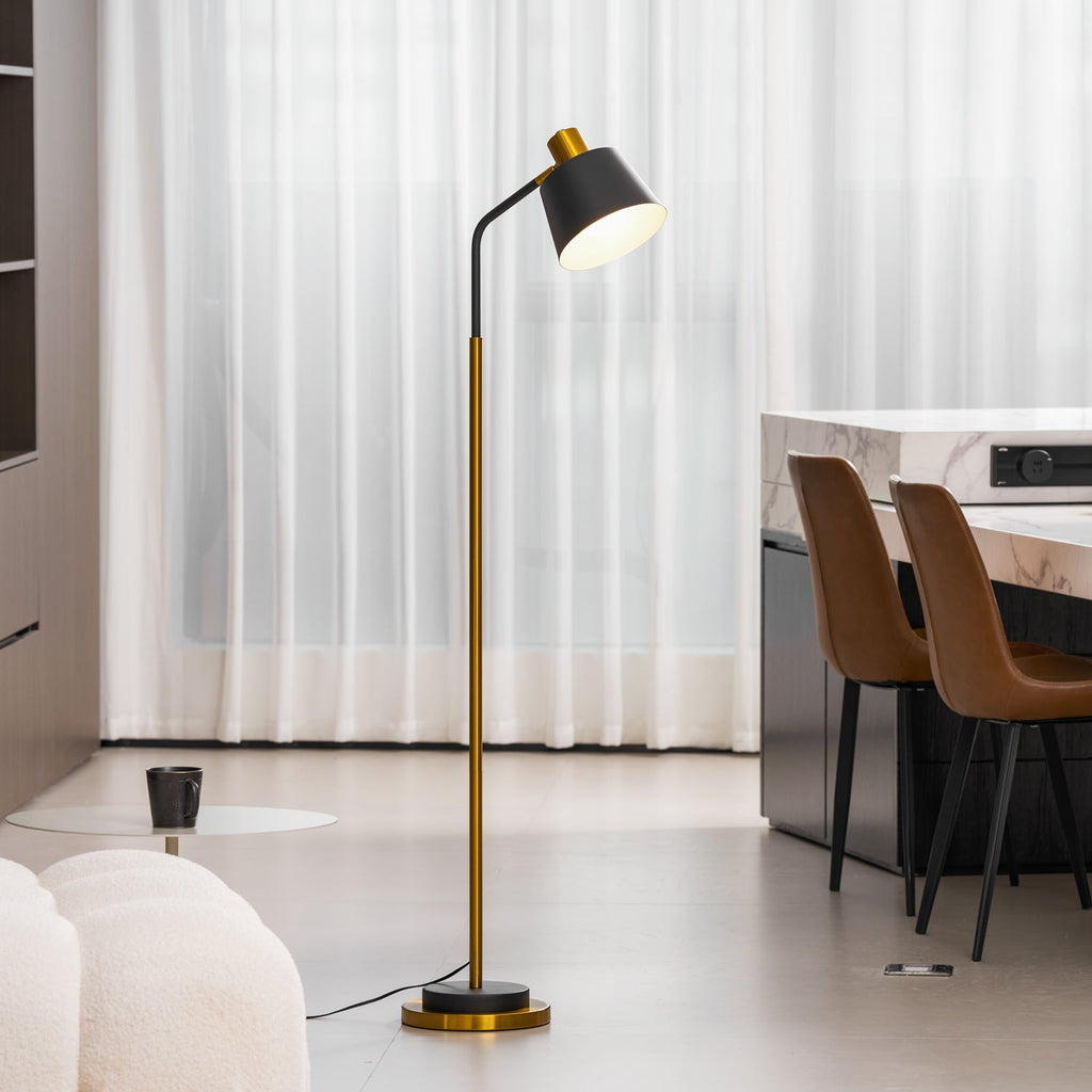 Clérachic floor lamp with a black shade glowing beside a dining area, with leather chairs and a boucle seat in view.
