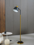 Close-cropped view of this Clérachic floor lamp's black shade over a marble-footed side table on a pale floor.