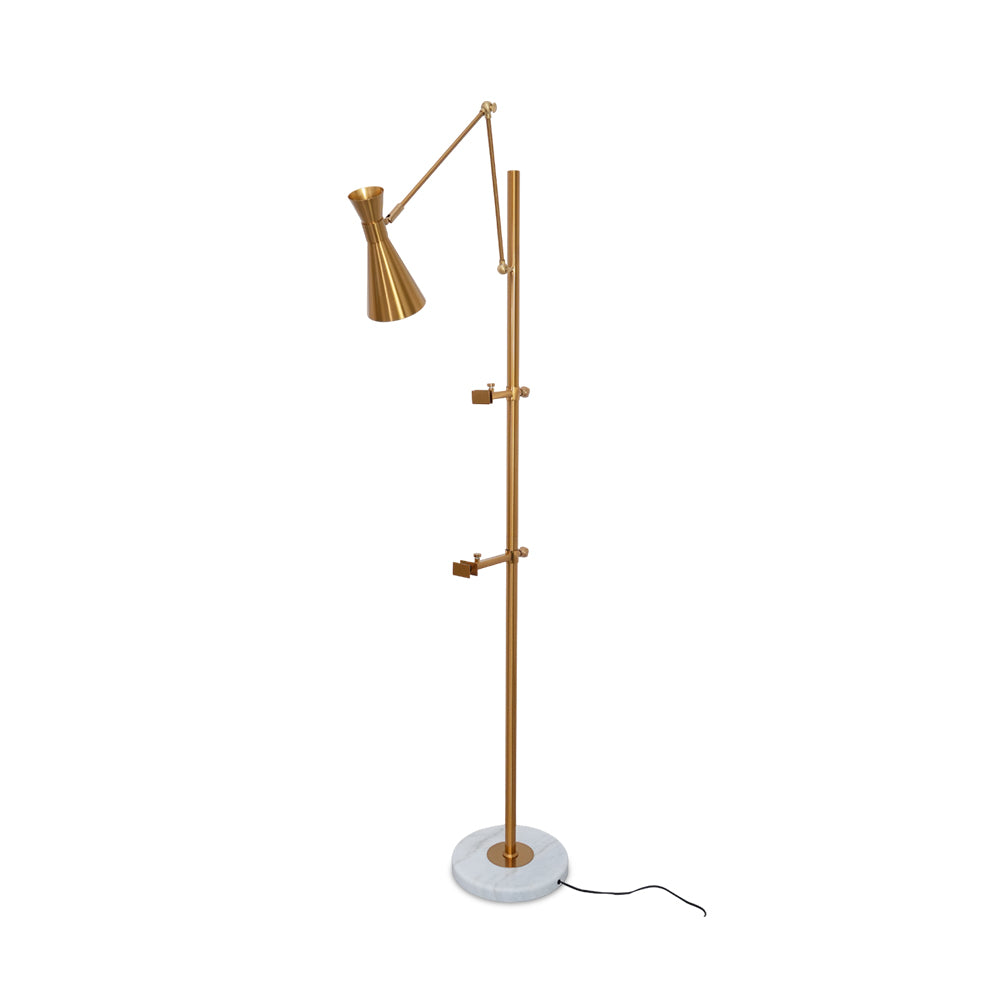 Gold Clérachic floor lamp on a white backdrop, with an angled arm and cone shade, two small picture arms on the pole and a white marble base.