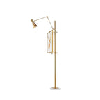 Clérachic gold floor lamp seen from the side, with a framed picture on the pole and an angled arm and cone shade at the top.