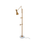A Clérachic gold floor lamp on a white backdrop, showing the cone shade, two clamp arms and a black cord from the marble base.