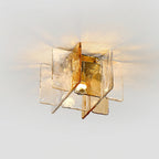 Angled view of this Clérachic ceiling light, with its textured amber and clear glass panes and the bulb glowing at the centre.