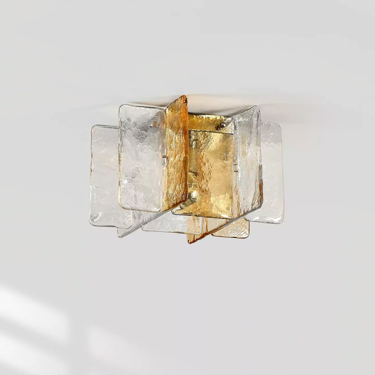 This Clérachic flush-mount light, switched off, shows its clear and amber glass panes and the metal frame against a pale grey ceiling.
