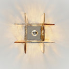 View from directly below at this Clérachic ceiling light, with its square metal base plate and bulb ringed by clear and amber glass panes.