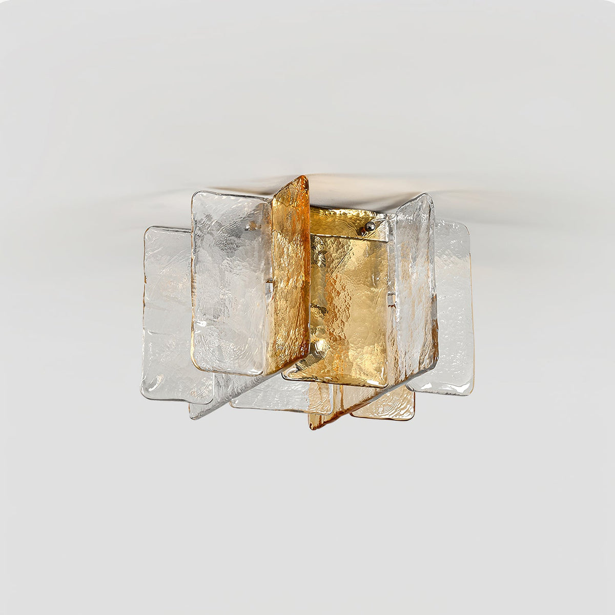 Unlit Clérachic ceiling light with overlapping clear and amber glass panes, photographed from below against a light grey ceiling.