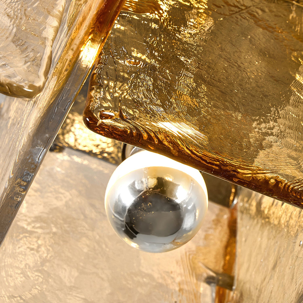 Close view of the amber glass pane and a silver-coated bulb tucked inside the frame of this Clérachic ceiling light.