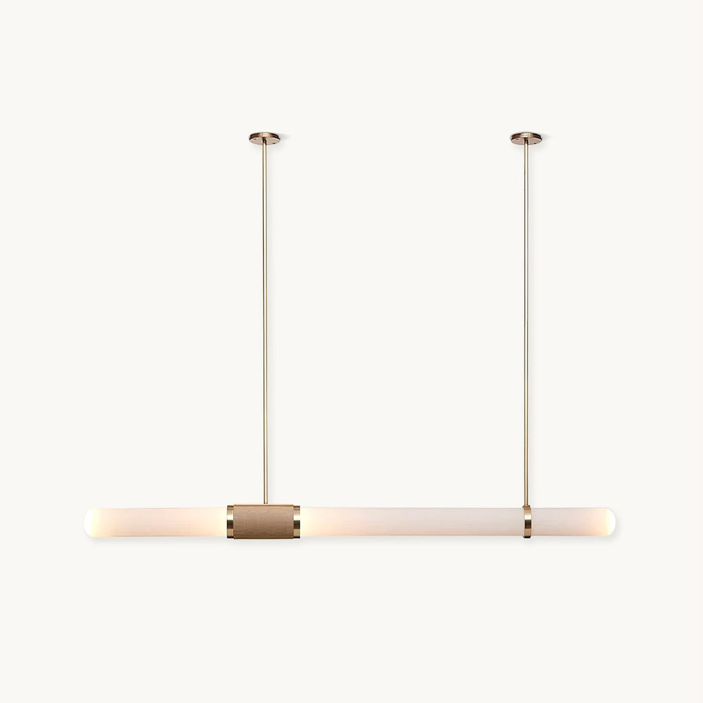 A Clérachic pendant light on a plain white backdrop, a long frosted tube hung from two slim gold rods with a woven band at its centre.