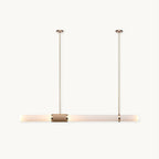 A Clérachic pendant light on a plain white backdrop, a long frosted tube hung from two slim gold rods with a woven band at its centre.