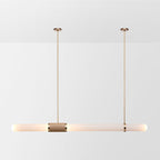This Clérachic pendant light on a soft white backdrop, a long frosted tube hung level from two gold rods with a woven centre band.