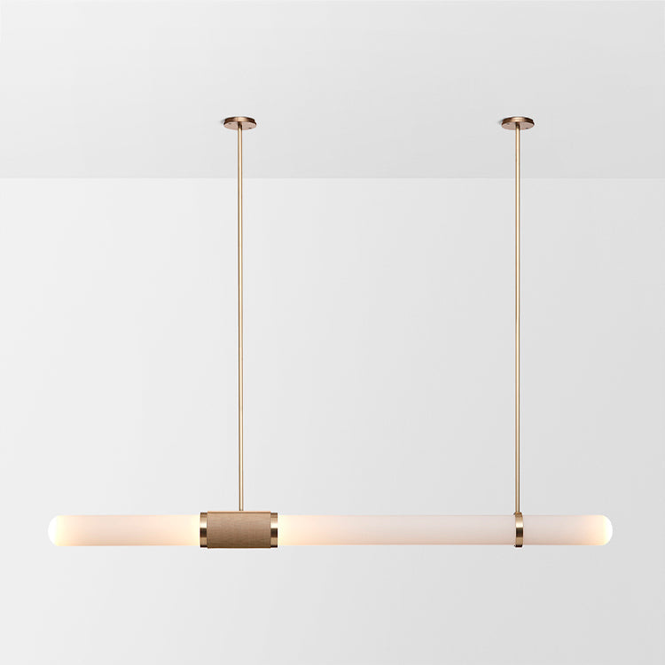 This Clérachic pendant light on a soft white backdrop, a long frosted tube hung level from two gold rods with a woven centre band.