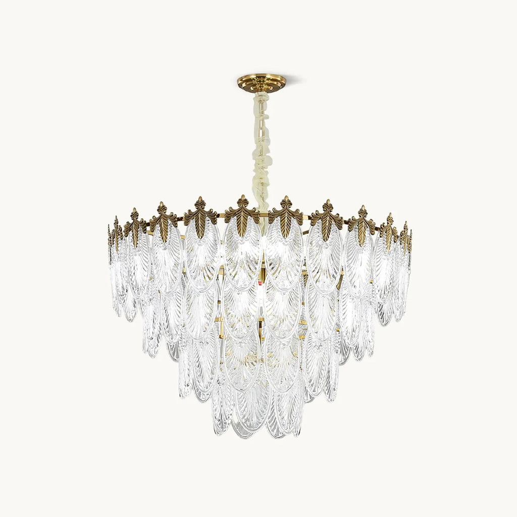 A Clérachic chandelier on a plain white backdrop, with overlapping clear glass leaf shades under a gold crown and a gold canopy on a chain.