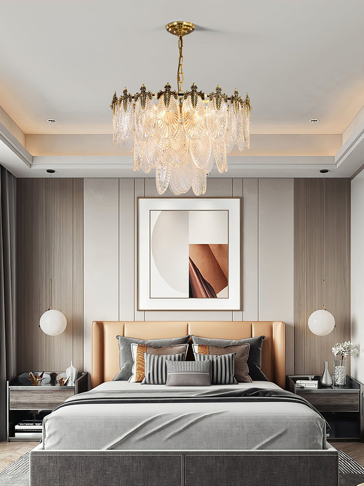 Clérachic leaf chandelier lit above a bed with a tan headboard and grey bedding, in a bedroom with a recessed ceiling and framed art.