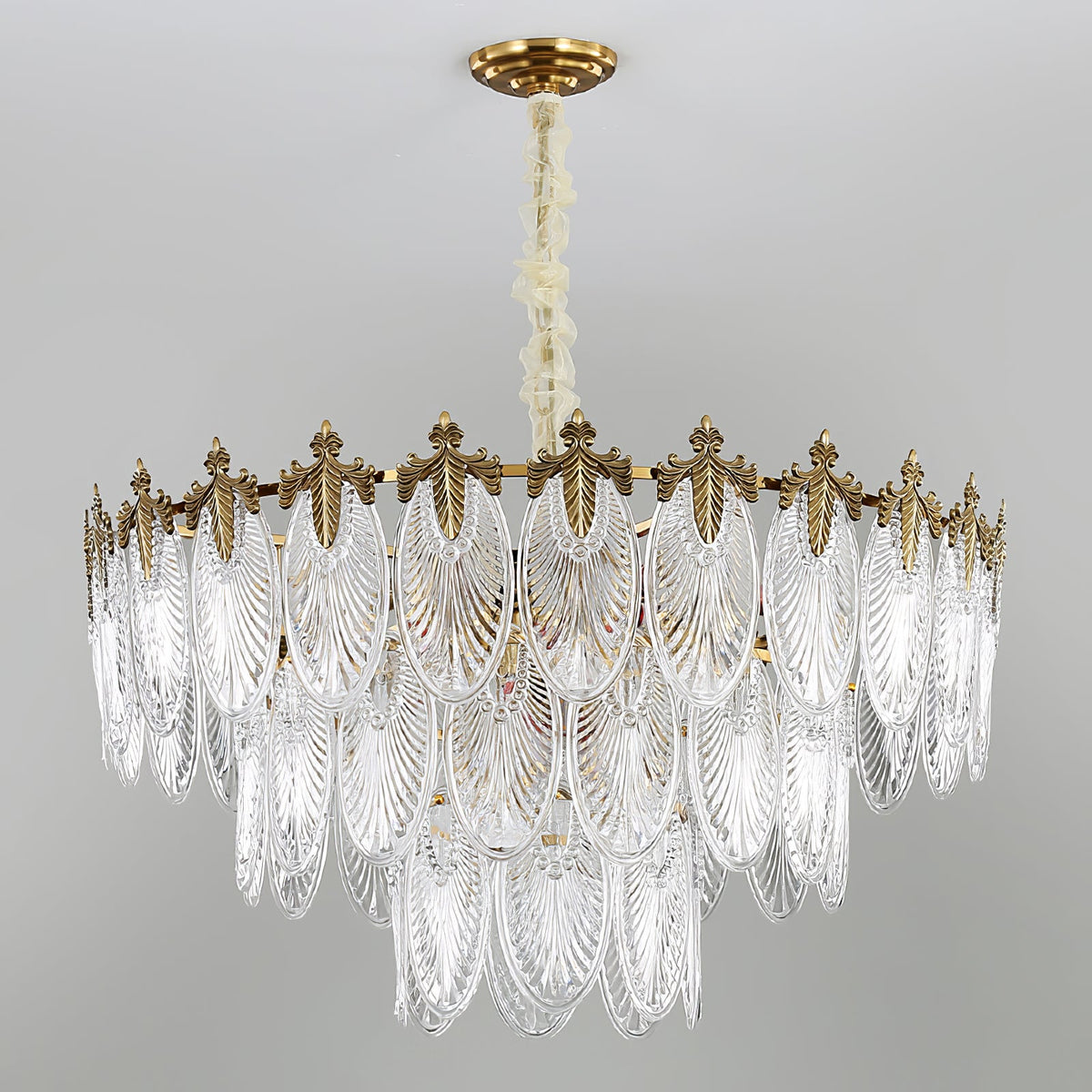Wide unlit Clérachic chandelier on a grey backdrop, showing three tiers of clear ribbed glass leaves beneath a gold crown.