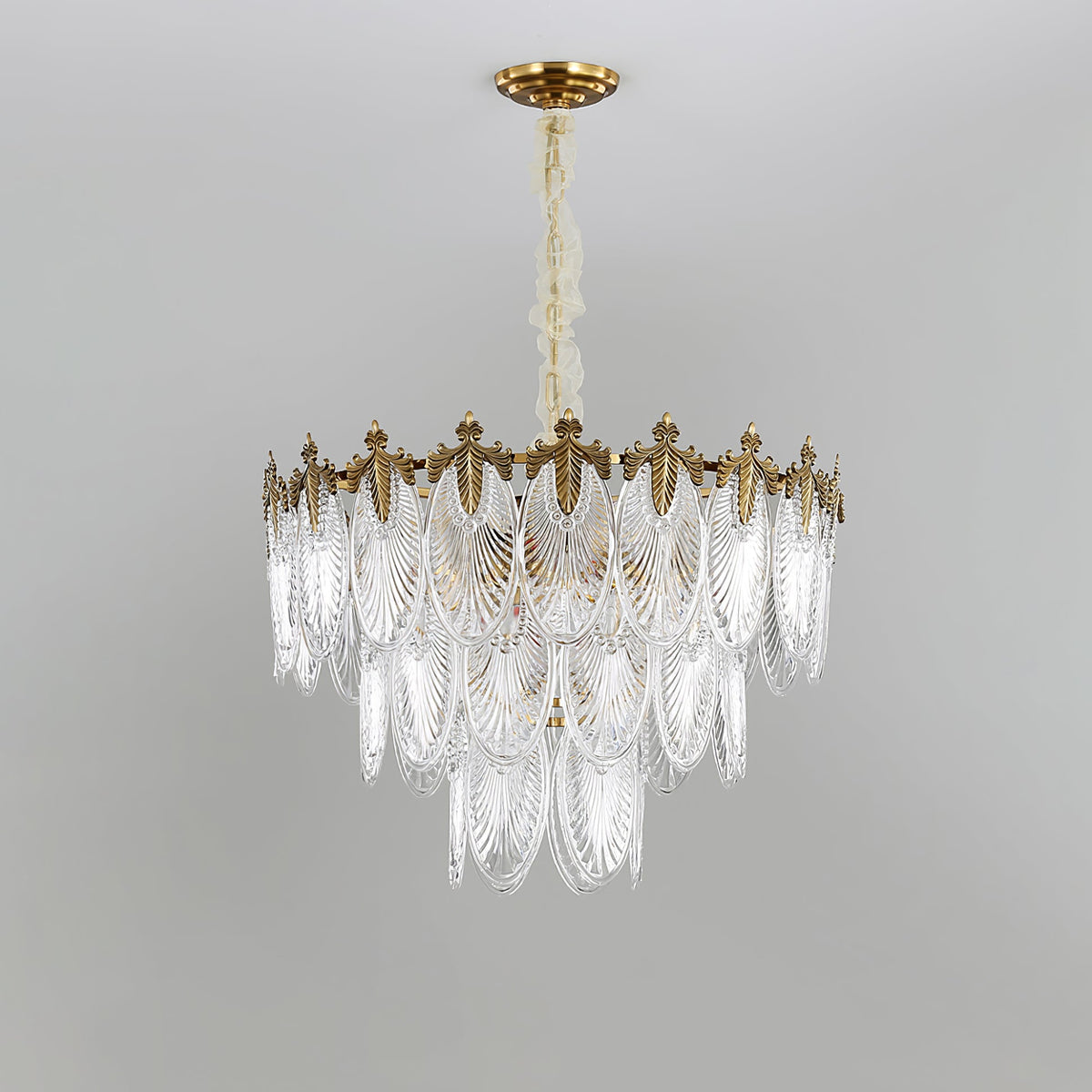 Tall four-tier Clérachic chandelier on a grey backdrop, its clear glass leaves narrowing towards the bottom, unlit.