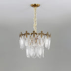 Two-tier Clérachic chandelier on a grey backdrop, with a longer chain and a lower tier of glass leaves hanging below the crown, unlit.