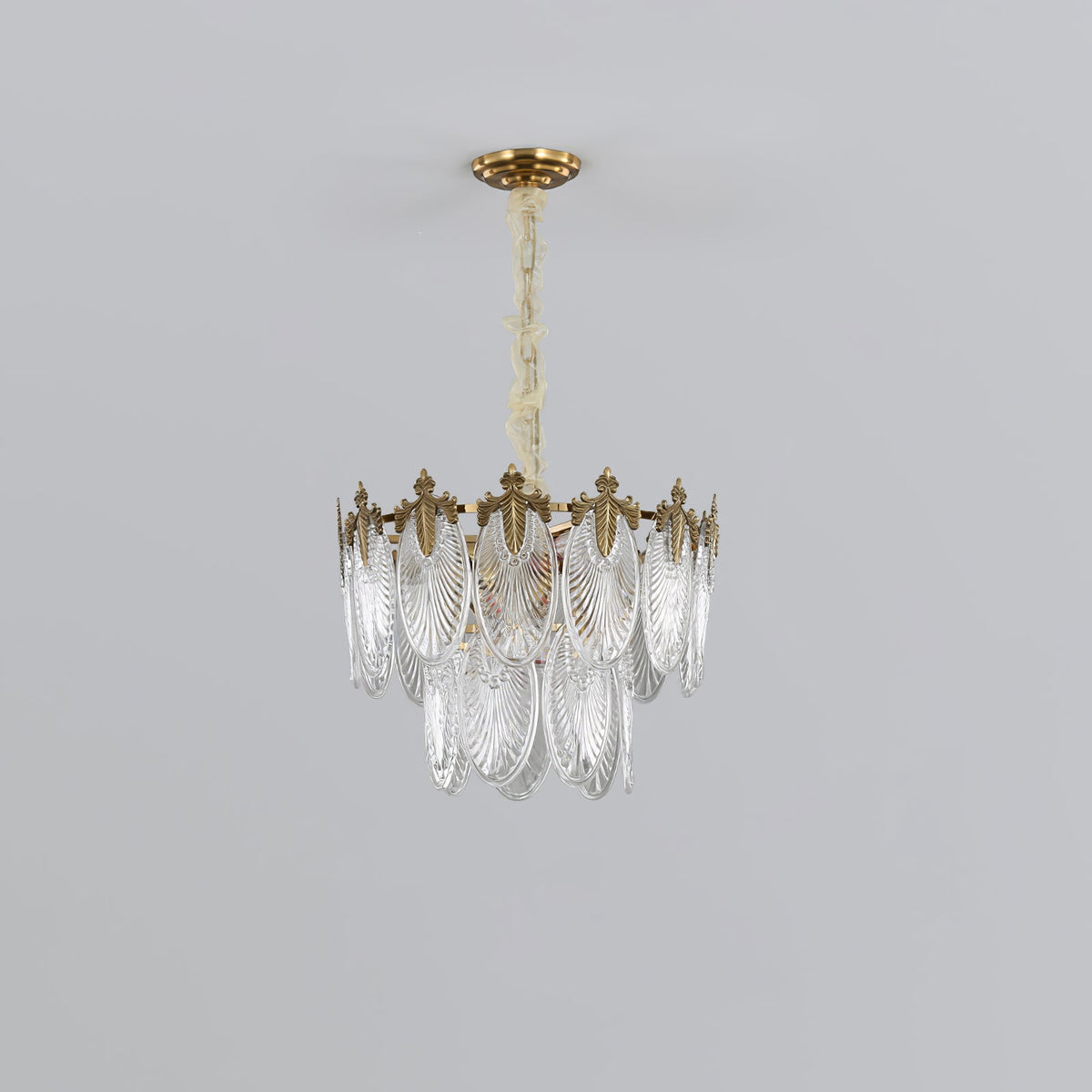 Small two-tier Clérachic chandelier on a light grey backdrop, with clear glass leaves under a gold crown, unlit.