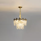 Lit compact Clérachic chandelier on a grey backdrop, with two tiers of glass leaves and a gold canopy above.