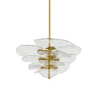 Clear glass Clérachic chandelier on white, with a brass finial at the base and petals stacked on gold spacers.