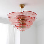 Pink Clérachic petal chandelier seen from below, with wide rippled glass discs in tiers around a central brass rod.