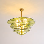 Green Clérachic chandelier on a short brass rod, lit, with warm light across the ceiling and olive glass petals below.