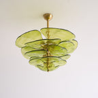 Unlit green Clérachic chandelier with a short brass rod, its thick olive glass petals layered like leaves on a white backdrop.