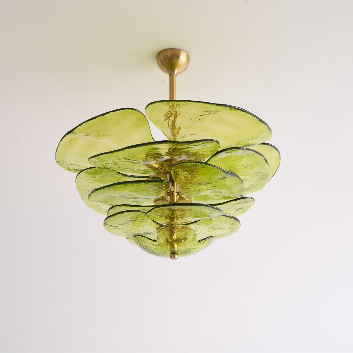 Unlit green Clérachic chandelier with a short brass rod, its thick olive glass petals layered like leaves on a white backdrop.