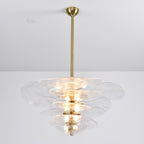 Clear Clérachic petal chandelier on a long brass rod, with lit bulbs showing through the rippled glass tiers.
