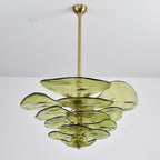 Unlit green Clérachic chandelier on a long brass rod, with large olive petals spreading out in uneven tiers on a grey backdrop.