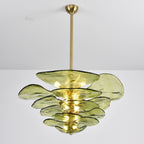 Lit green Clérachic chandelier on a long brass rod, its olive petals glowing from the bulbs inside the tiers.