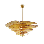 Amber Clérachic chandelier with gold fittings on a white backdrop, with orange-edged petals stacked below a short brass rod.