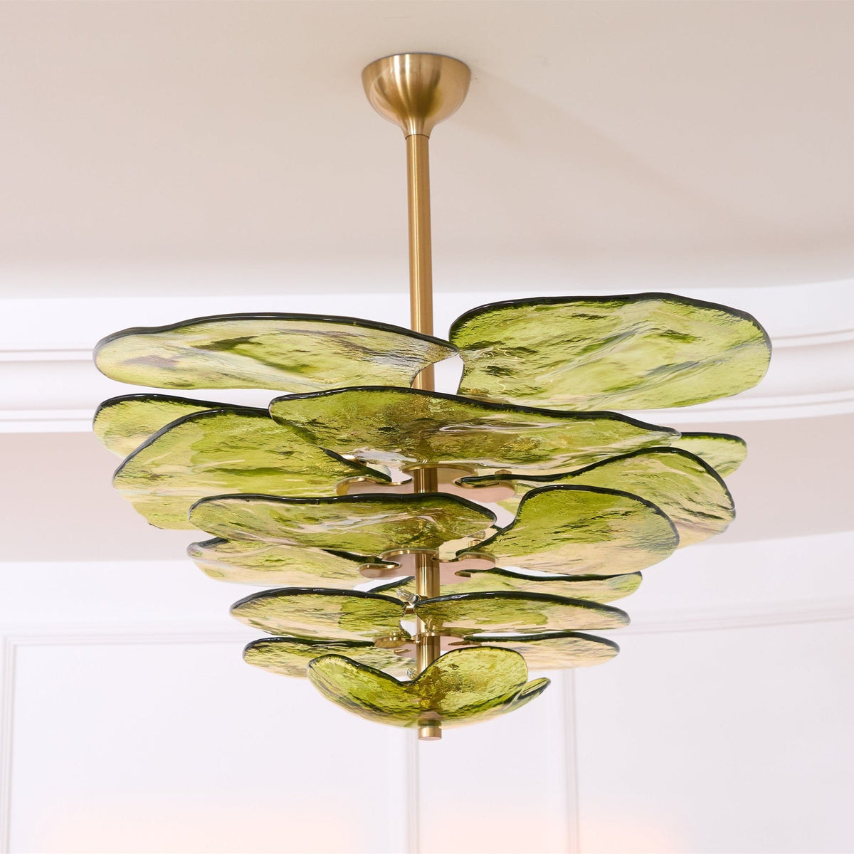 Large green Clérachic chandelier seen from below, with a thick brass rod and overlapping petals of rippled olive glass.