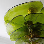 Close view of overlapping olive glass petals on this Clérachic chandelier, with a hint of the brass fitting at the centre.