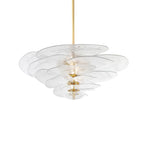 Clear glass Clérachic chandelier on a white backdrop, with pale rippled petals in tiers on a long brass rod and a lit centre.