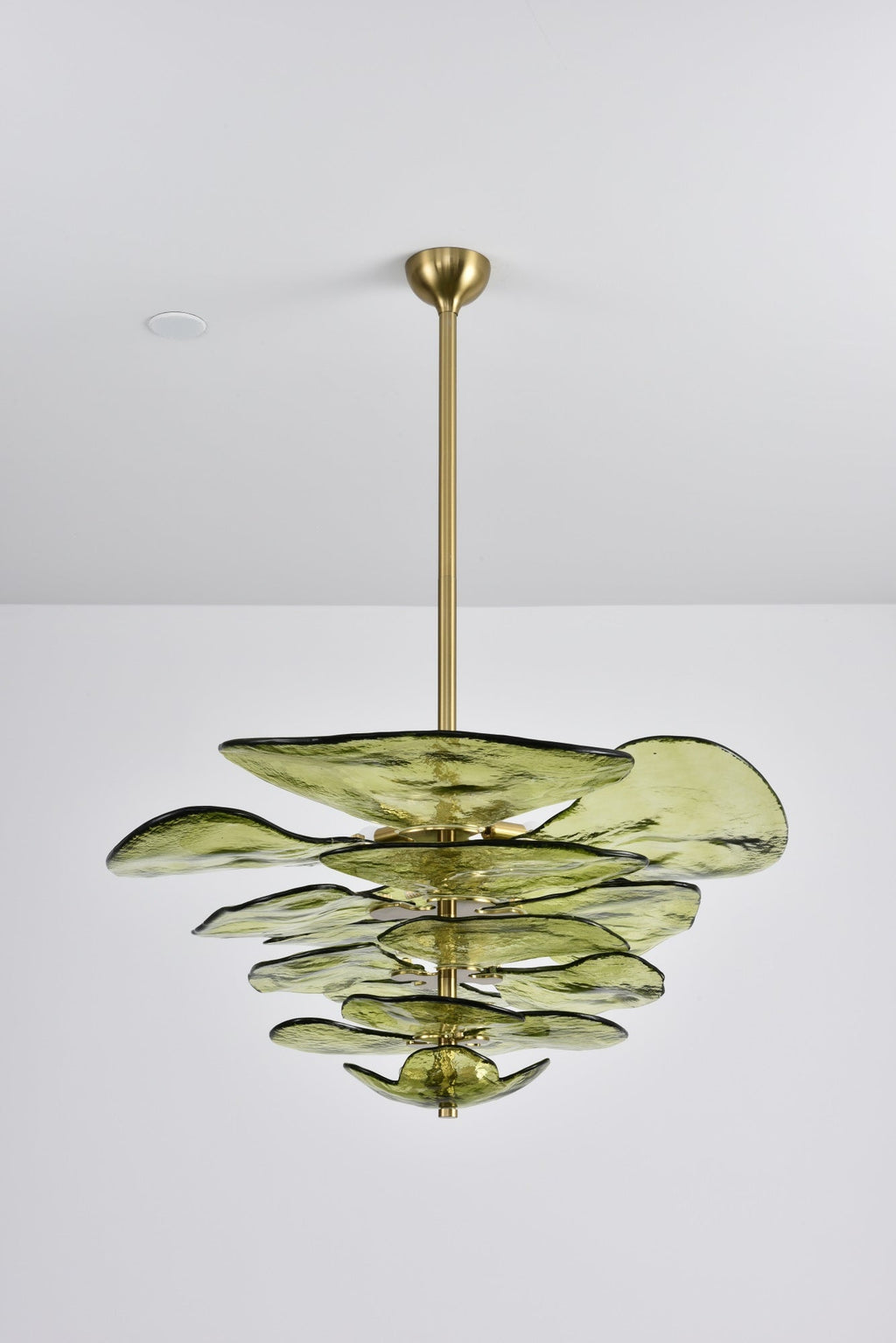 Unlit green Clérachic chandelier on a long brass rod, the olive petals showing their rippled surface on a grey backdrop.