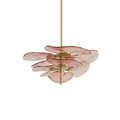 Low, wide pink Clérachic chandelier on white, with a few translucent petals fanned out around a brass spindle.