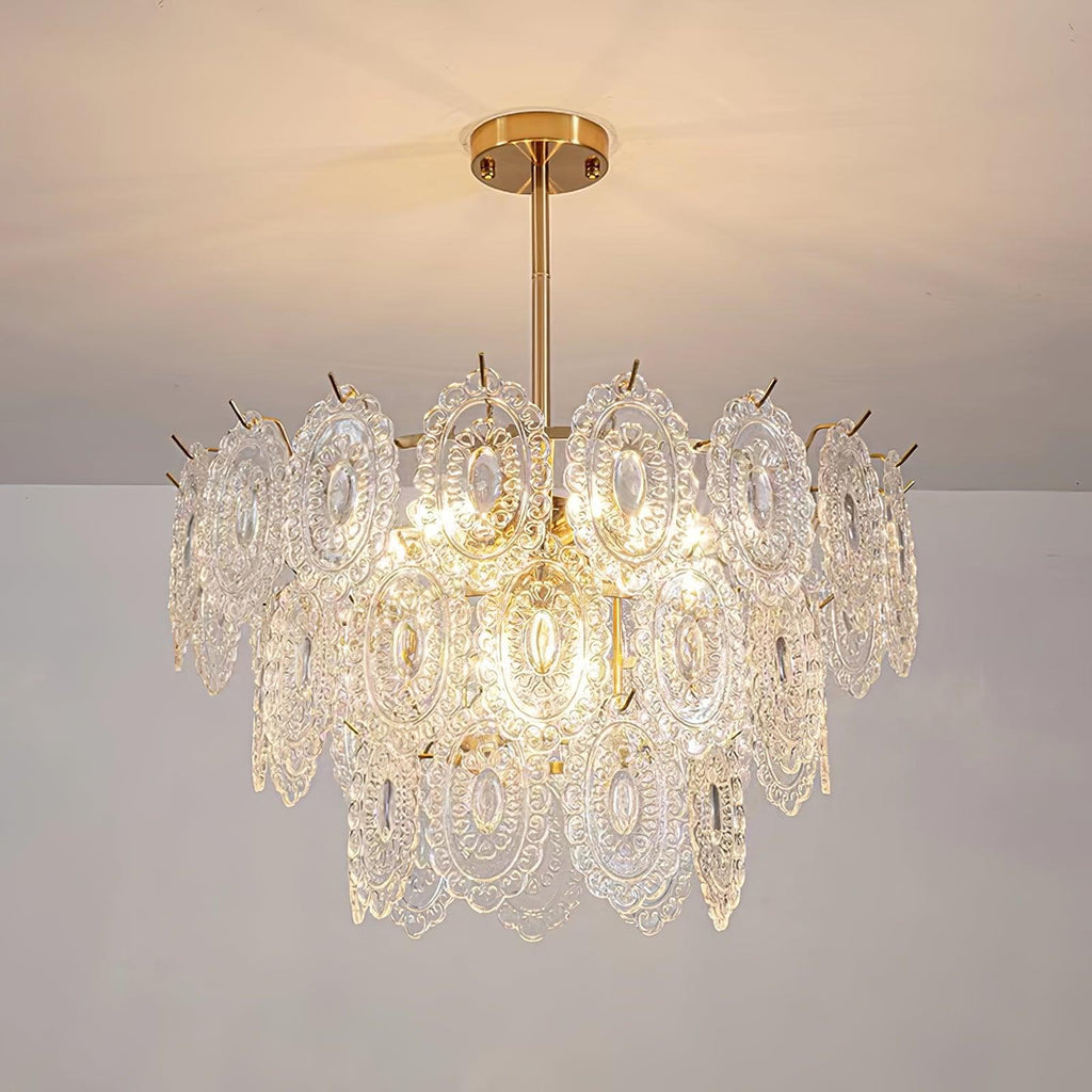 Clérachic pendant on a gold canopy and short rod, lit warm against a cream ceiling and a pale grey wall.
