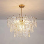 Clérachic pendant on a gold canopy and short rod, lit warm against a cream ceiling and a pale grey wall.
