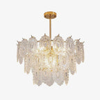 Clérachic gold-framed pendant with three tiers of oval, textured clear glass panels, photographed on a plain light backdrop.