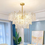 Clérachic glass pendant in a living room with white curtains, a blue wall and a large abstract painting in pale gold tones.