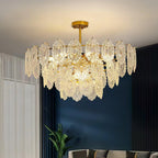 Wide Clérachic glass pendant in a living room with a deep blue wall, white sheer curtains and a plant in the corner.