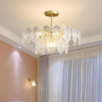 Clérachic glass pendant under a white cornice in a bedroom, with sheer curtains and a pink wall and wall light beside it.