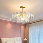 Clérachic pendant with a gold canopy glowing in a bedroom with a pink wall, a white tufted headboard and gold curtain rail.