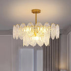 Warm-lit Clérachic pendant in a grey panelled room with a gold canopy, showing the glass panels in close detail.