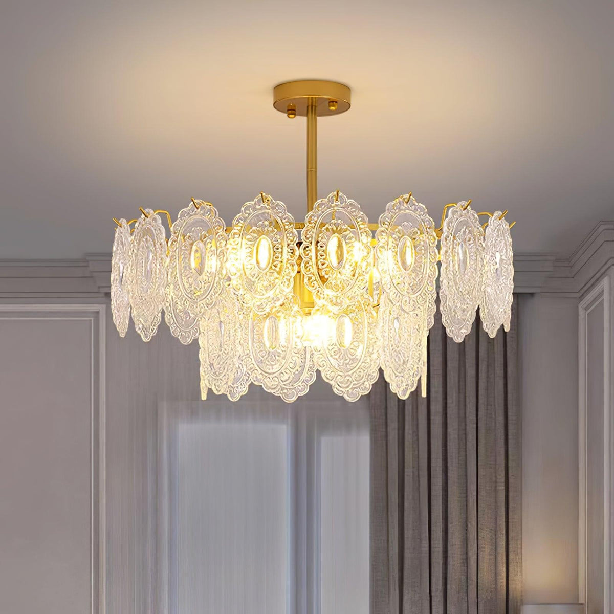 Warm-lit Clérachic pendant in a grey panelled room with a gold canopy, showing the glass panels in close detail.