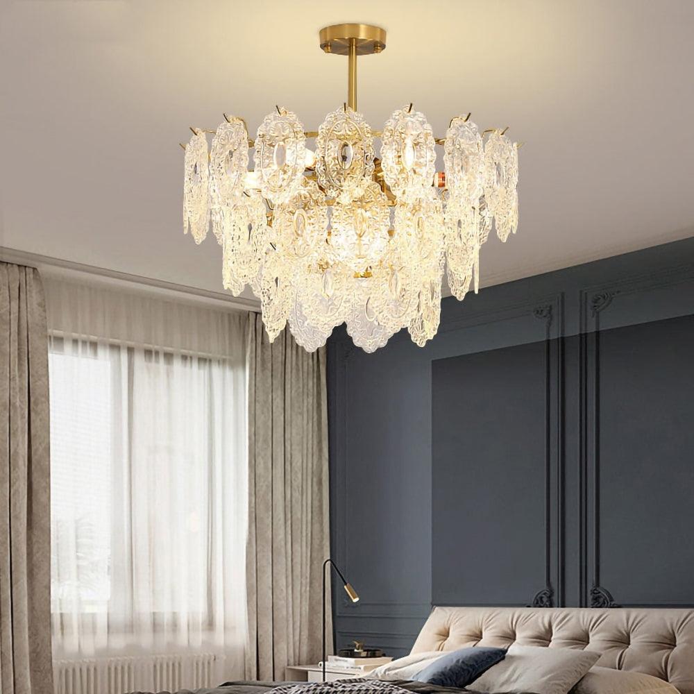 Clérachic glass pendant lit above a grey wall with white wall panels, tall sheer curtains and a dark armchair at the edge.